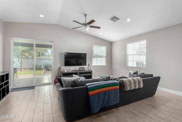 living room featuring ceiling fan, vaulted ceiling, and light hardwood / wood-style flooring