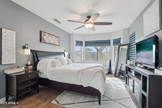 bedroom featuring wood finished floors, visible vents, and ceiling fan