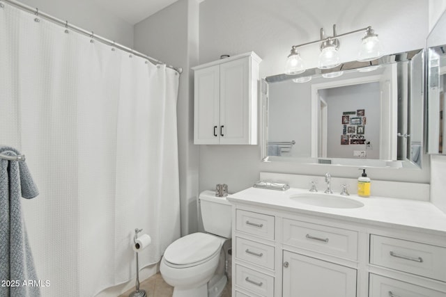 bathroom with vanity, toilet, and tile patterned flooring