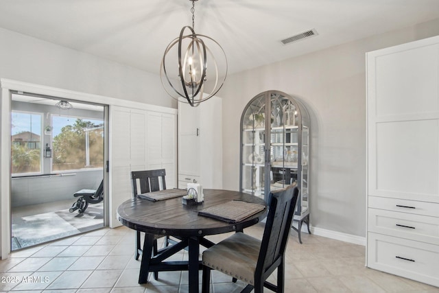 dining space featuring light tile patterned floors, visible vents, baseboards, and an inviting chandelier