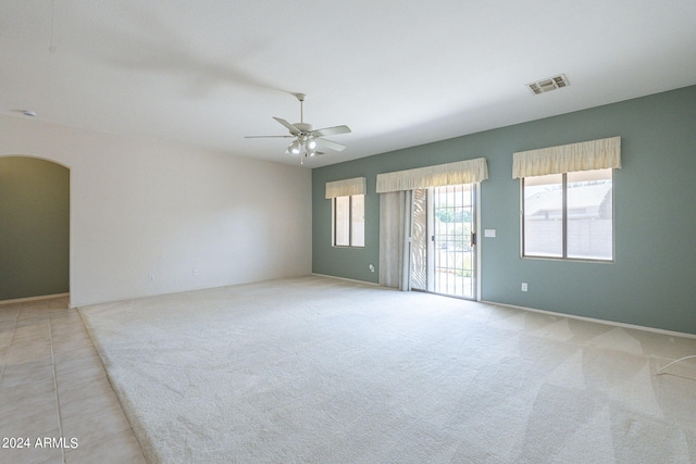 empty room featuring light tile patterned floors and ceiling fan