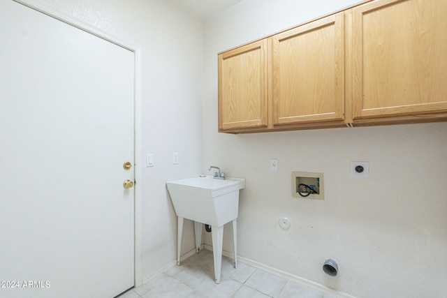 laundry area featuring cabinets, electric dryer hookup, hookup for a washing machine, light tile patterned flooring, and hookup for a gas dryer