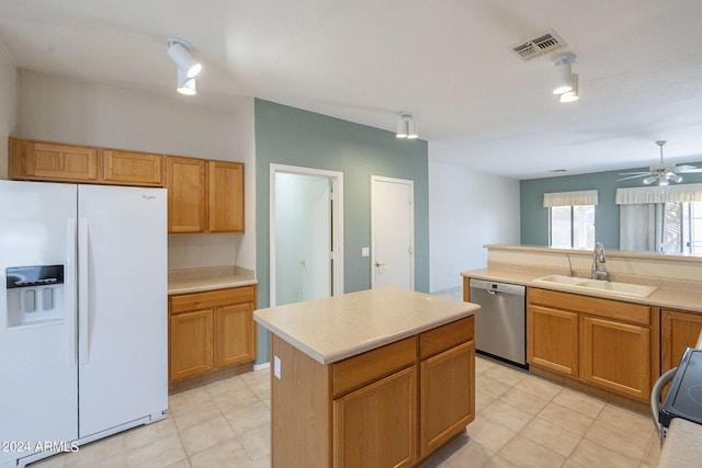 kitchen with white refrigerator with ice dispenser, dishwasher, a center island, sink, and ceiling fan