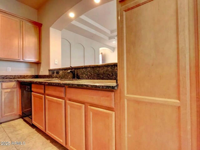 3820 E Mcdowell Rd Unit 102, Phoenix, AZ 85008 - kitchen featuring a sink, dark stone counters, black dishwasher, and arched walkways
