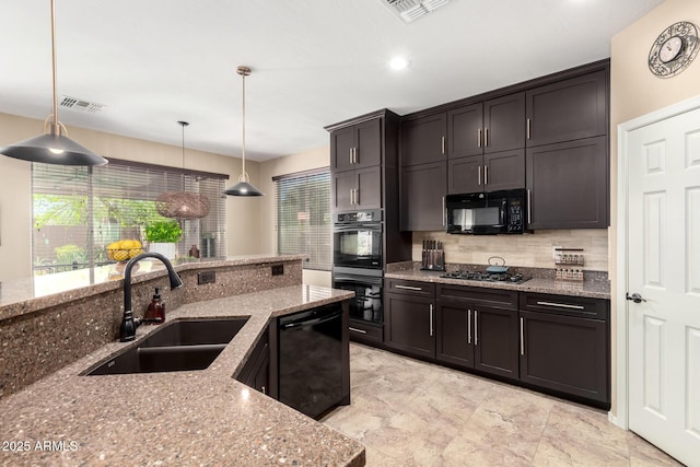 kitchen featuring light stone counters, black appliances, backsplash, a sink, and visible vents