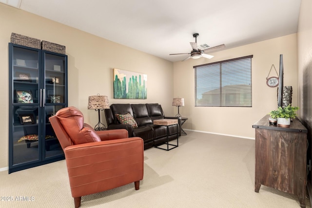 carpeted living room featuring ceiling fan, visible vents, and baseboards