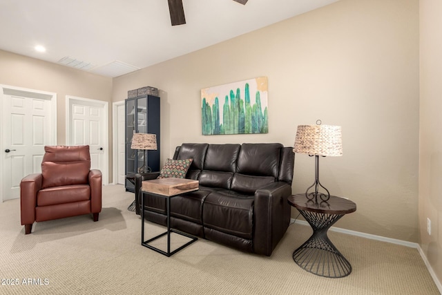 living room with baseboards, visible vents, ceiling fan, and light colored carpet