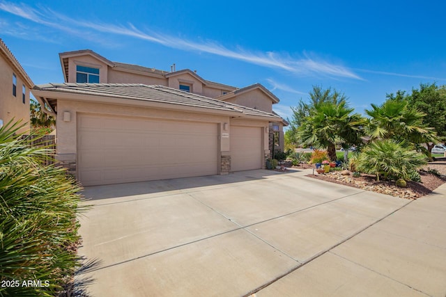 mediterranean / spanish home featuring driveway, stone siding, a tiled roof, stucco siding, and a garage