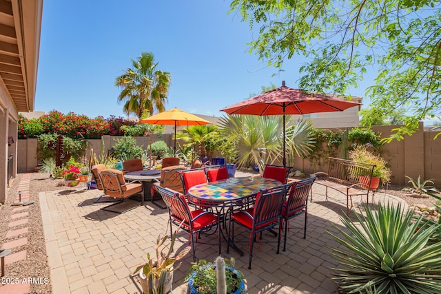 view of patio featuring outdoor dining area and a fenced backyard