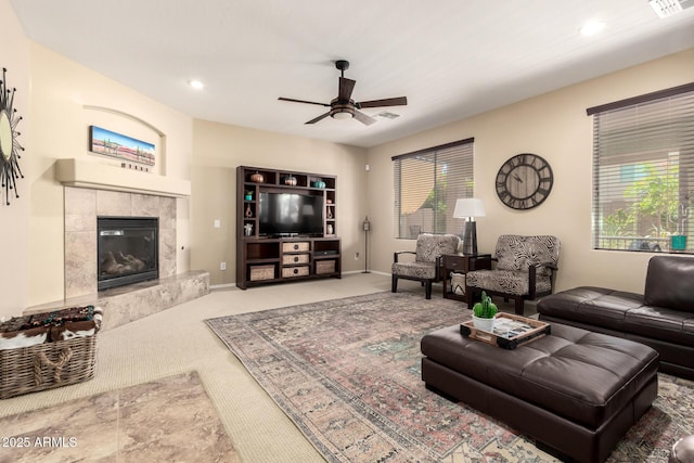 carpeted living area with a high end fireplace, recessed lighting, ceiling fan, and visible vents