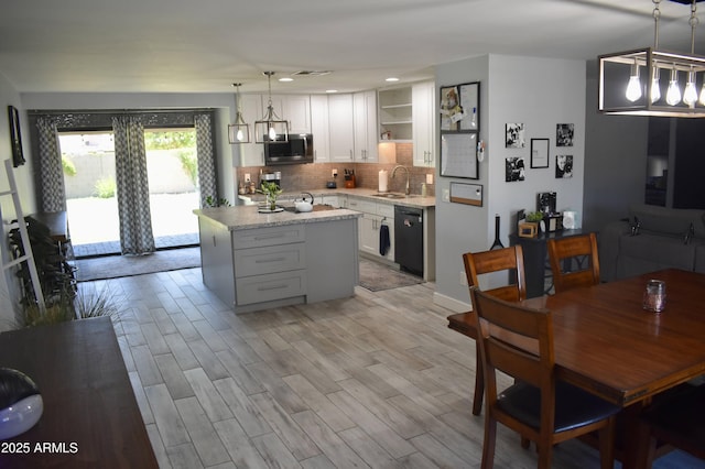 4755 E Gary St, Mesa, AZ 85205 - kitchen with stainless steel microwave, black dishwasher, open shelves, backsplash, and a kitchen island
