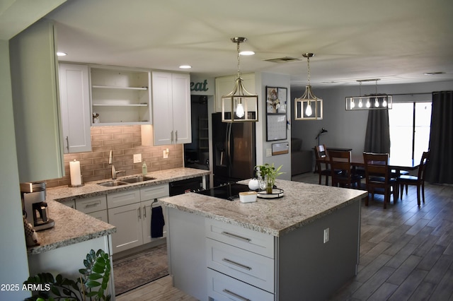 4755 E Gary St, Mesa, AZ 85205 - kitchen with black appliances, tasteful backsplash, open shelves, white cabinetry, and a kitchen island