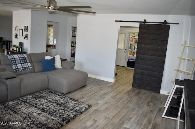 4755 E Gary St, Mesa, AZ 85205 - living room featuring a barn door, a ceiling fan, and wood finished floors