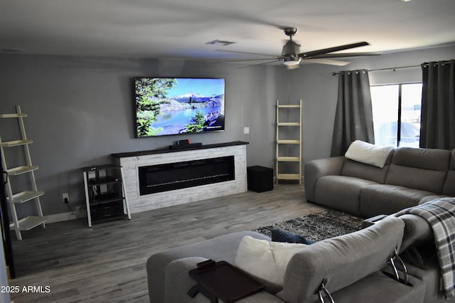 4755 E Gary St, Mesa, AZ 85205 - living area featuring a glass covered fireplace, a ceiling fan, and wood finished floors