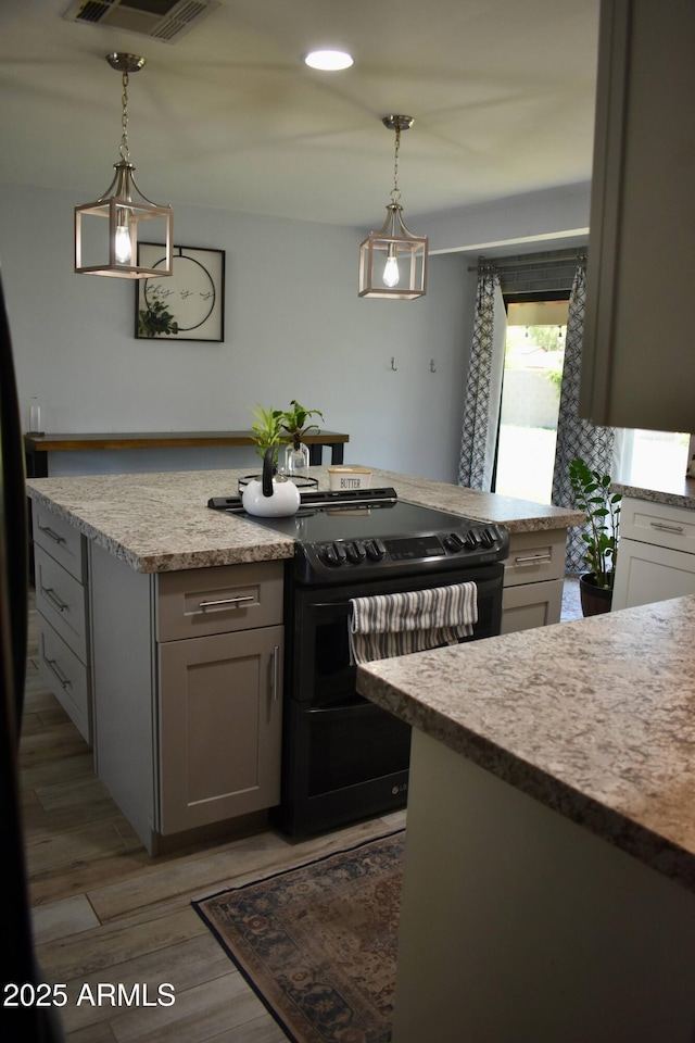 4755 E Gary St, Mesa, AZ 85205 - kitchen with black electric range oven, decorative light fixtures, wood finished floors, and a kitchen island