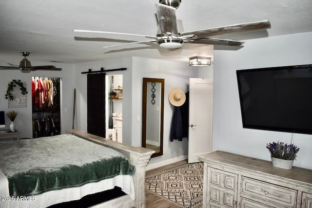 4755 E Gary St, Mesa, AZ 85205 - bedroom featuring a barn door, wood finished floors, ceiling fan, and a closet