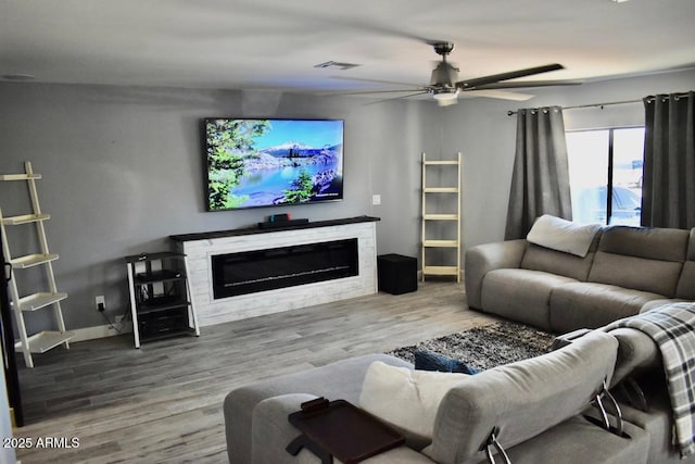 4755 E Gary St, Mesa, AZ 85205 - living room featuring a glass covered fireplace, a ceiling fan, and wood finished floors