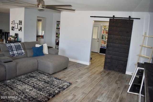 4755 E Gary St, Mesa, AZ 85205 - living area with a barn door, wood finished floors, and a ceiling fan