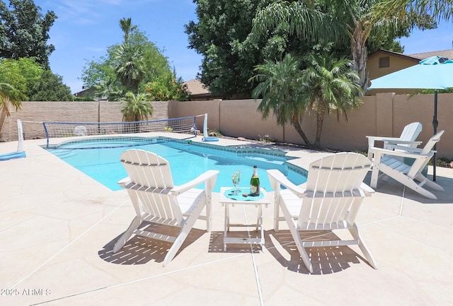 view of pool featuring a patio, a fenced in pool, and a fenced backyard