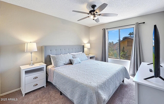 bedroom with a textured ceiling, baseboards, a ceiling fan, and dark carpet