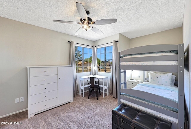 carpeted bedroom with a textured ceiling and a ceiling fan