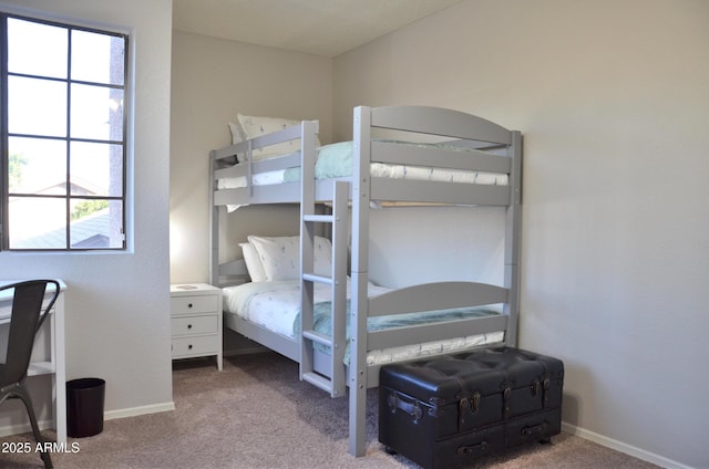 carpeted bedroom featuring baseboards