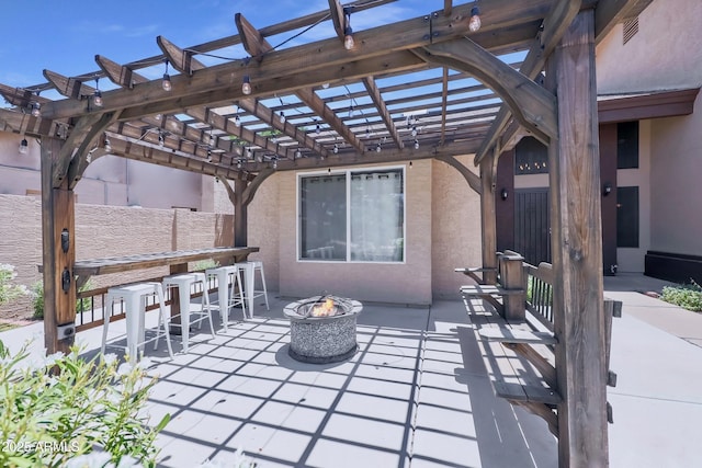 view of patio / terrace featuring outdoor dry bar, visible vents, a pergola, and a fire pit