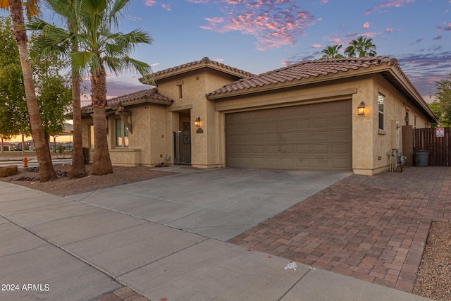 mediterranean / spanish home featuring a garage