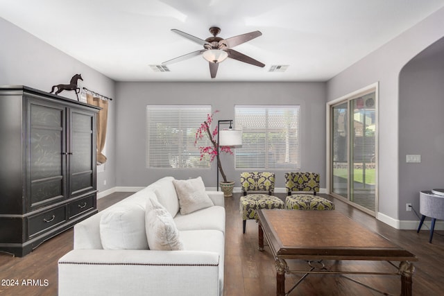 living room with dark hardwood / wood-style flooring and ceiling fan