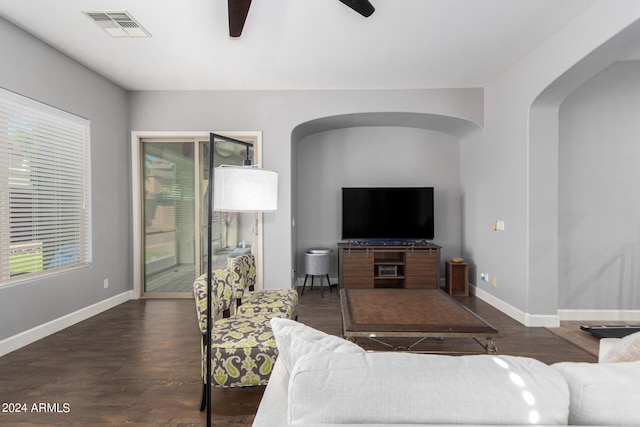 living room featuring dark hardwood / wood-style floors and ceiling fan