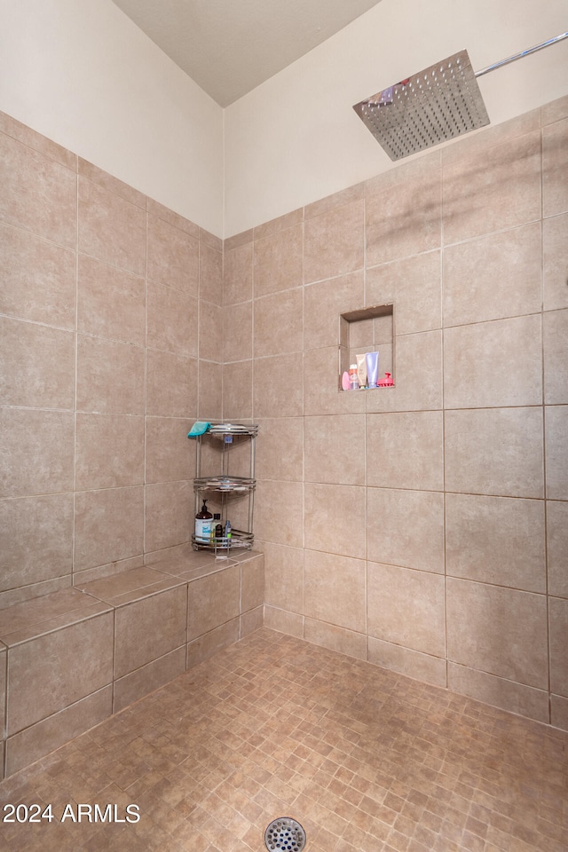 bathroom with a tile shower