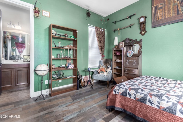 bedroom featuring dark hardwood / wood-style flooring, multiple windows, and ensuite bath