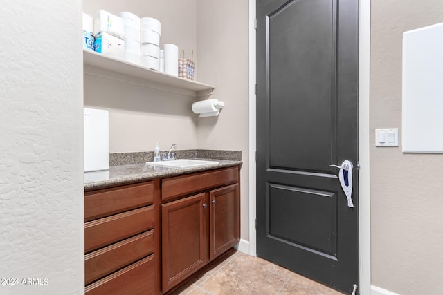 interior space with vanity and tile patterned floors