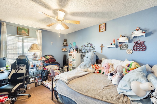 carpeted bedroom with a ceiling fan and a textured ceiling