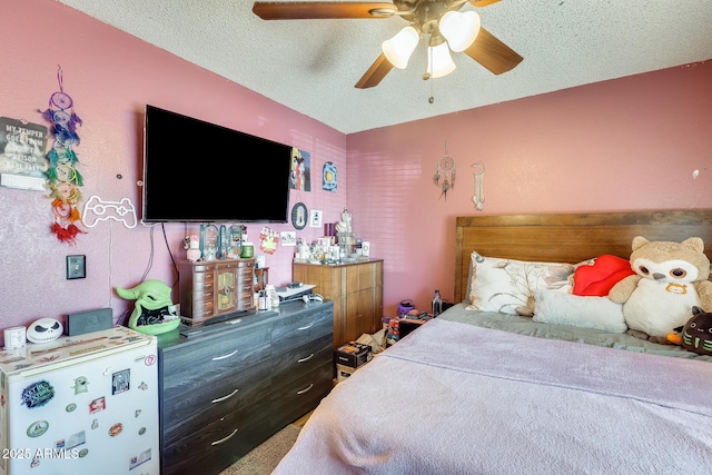 bedroom with a ceiling fan and a textured ceiling