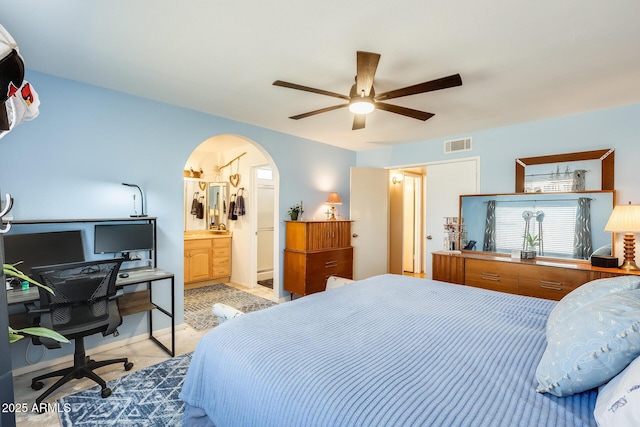 bedroom with a ceiling fan, arched walkways, visible vents, and ensuite bath