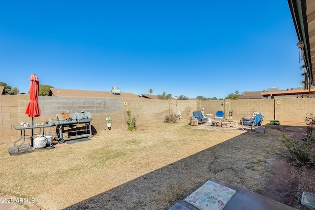 view of yard with a patio area and a fenced backyard