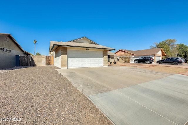 single story home featuring brick siding, concrete driveway, an attached garage, a gate, and fence