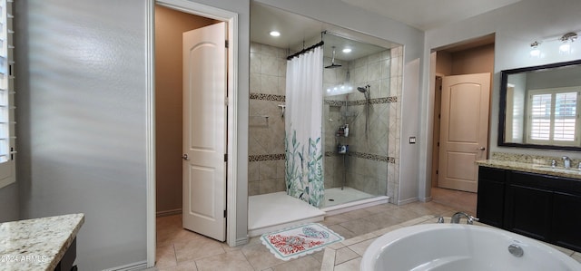 bathroom featuring tile patterned flooring, vanity, and plus walk in shower