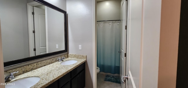 bathroom with vanity, toilet, curtained shower, and tile patterned flooring