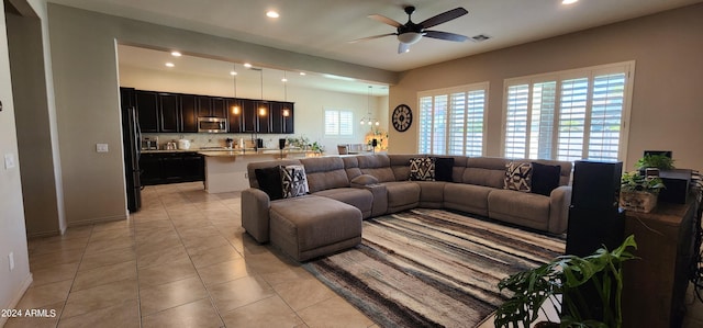 living room featuring ceiling fan and light tile patterned flooring