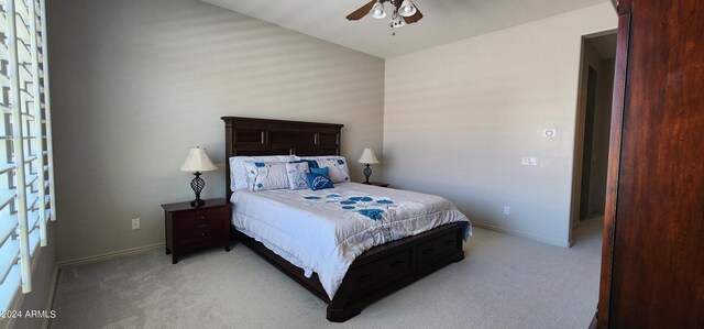 bedroom with light colored carpet and ceiling fan