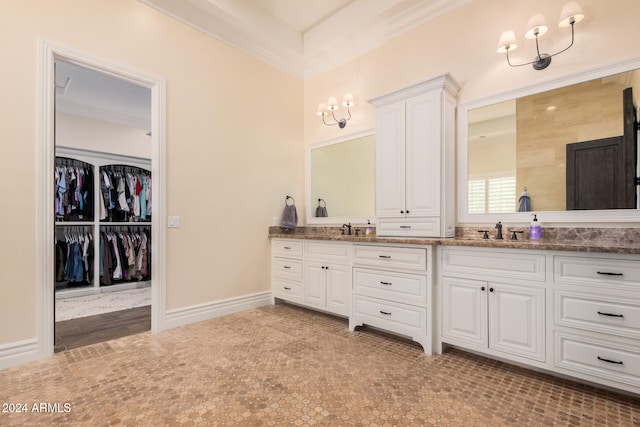 bathroom featuring crown molding and vanity