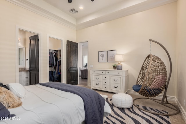 carpeted bedroom with ceiling fan, a spacious closet, a high ceiling, connected bathroom, and a closet