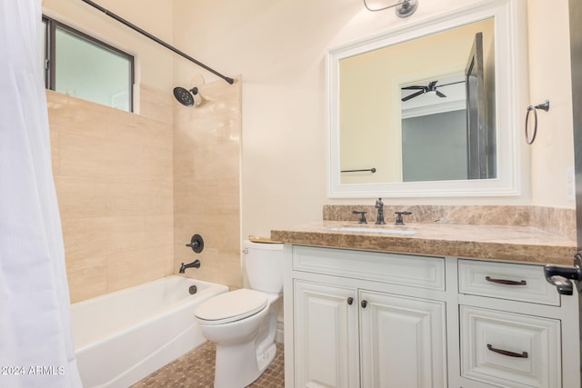 full bathroom featuring vanity, toilet, ceiling fan, and shower / bath combo with shower curtain