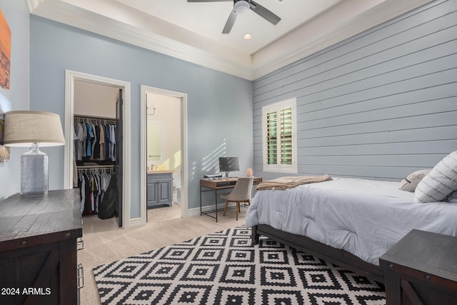 carpeted bedroom with a walk in closet, a closet, ceiling fan, and ensuite bathroom