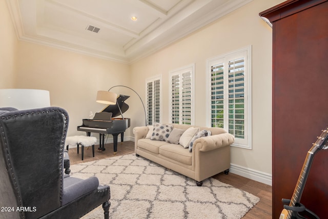 living room featuring beam ceiling, light wood-type flooring, ornamental molding, and coffered ceiling