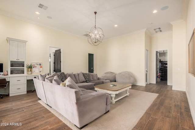 living room with crown molding, dark wood-type flooring, and an inviting chandelier