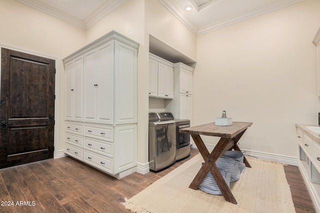 laundry room featuring crown molding, dark hardwood / wood-style flooring, cabinets, and independent washer and dryer