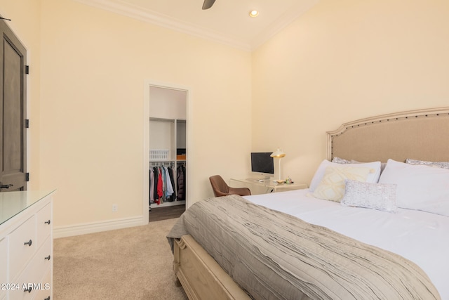 carpeted bedroom featuring a spacious closet, a closet, ceiling fan, and crown molding